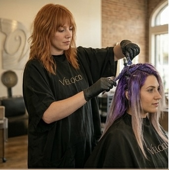 Lavender color process in progress — toning applied to pre-lightened hair