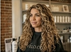 Curly blonde definition — defined curl pattern enhanced on natural blonde
