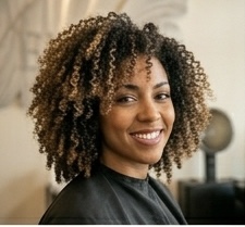 Curly highlights — dimensional color woven through natural curl texture